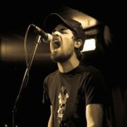 Thumbnail: With Friends Like These band Member, Brian Pake, performing live.